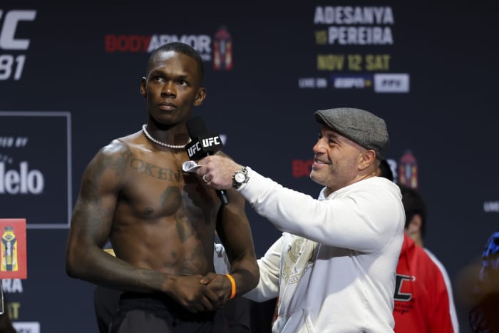Israel Adesanya is interviewed by UFC color commentator Joe Rogan at the UFC 281 ceremonial weigh-ins.